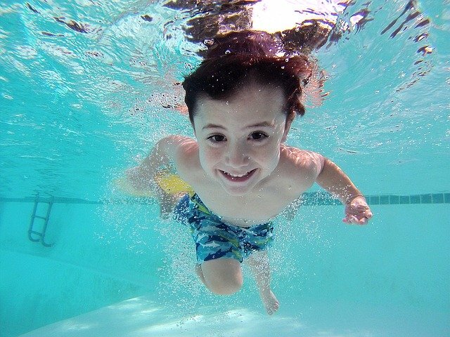 little boy swimming